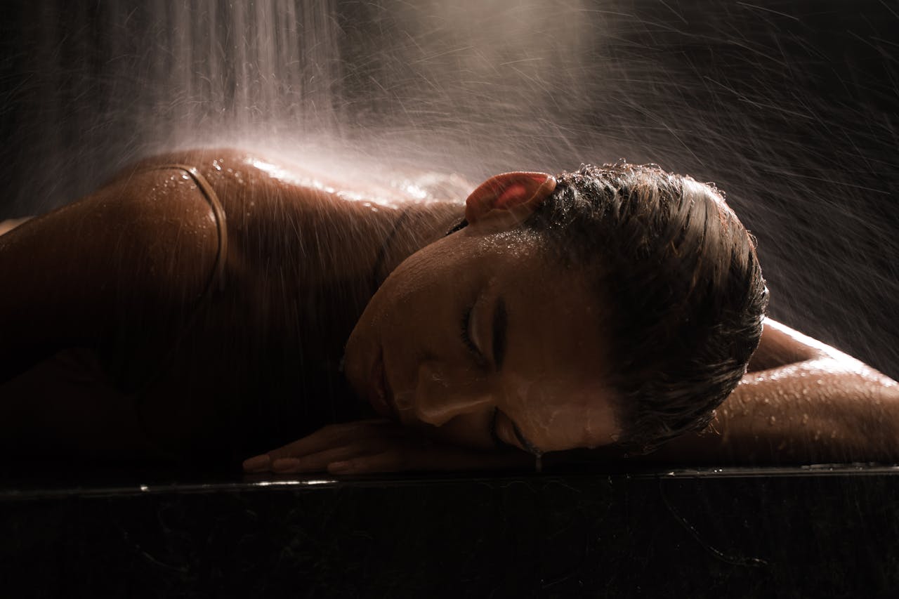 Young Woman Lying on a Marble Table in a Stream of Water